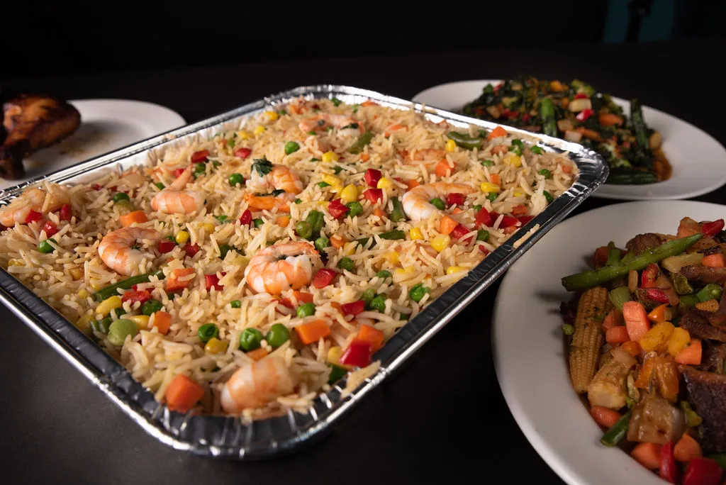 Shrimp fried rice tray with West African sides at Global Pot Fusion Cuisine - African restaurant Winnipeg MB