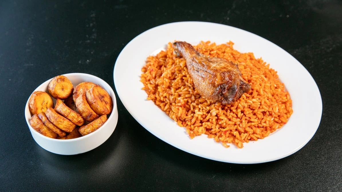Jollof rice with chicken and fried plantain - Best African food in Winnipeg at Global Pot Fusion Cuisine